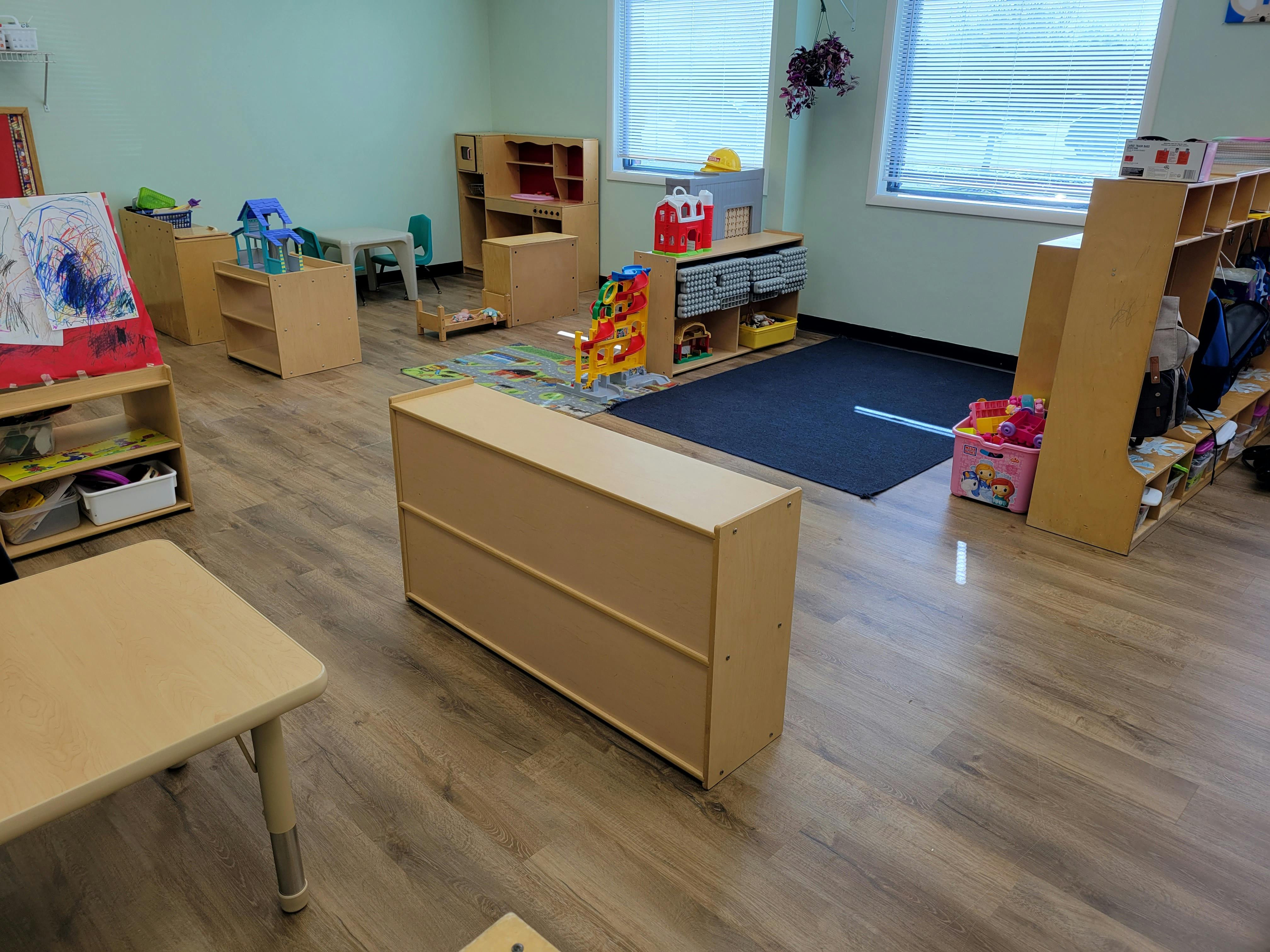 Empty classroom with wooden furniture and toys