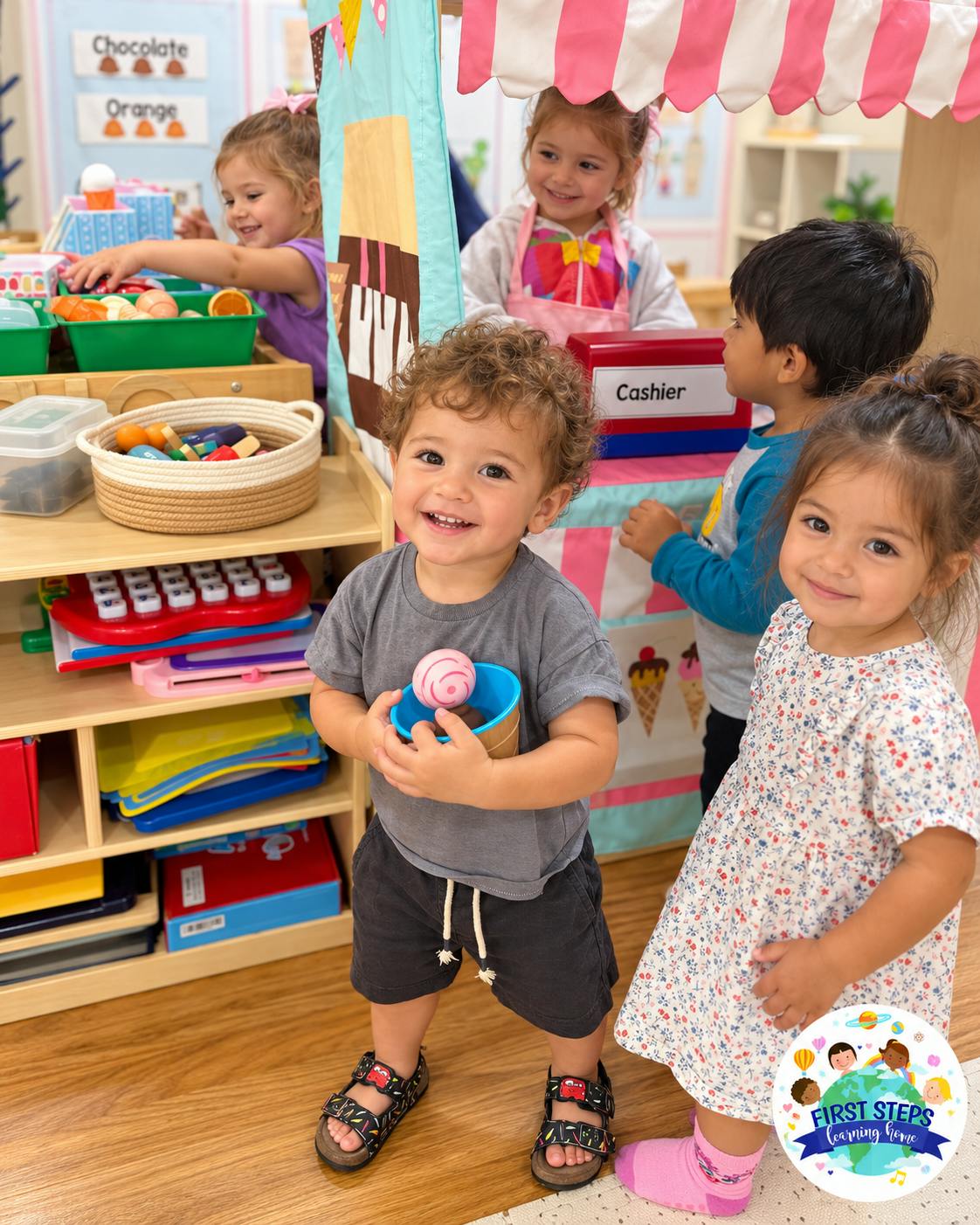 Group of children playing at a toy shop stand in a classroom