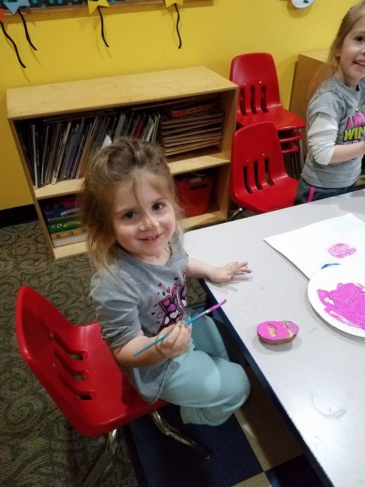 Child painting at a table