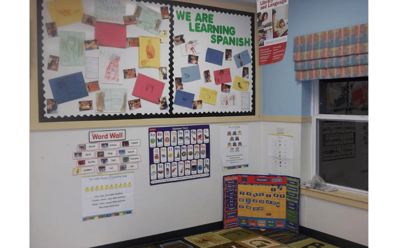 Spanish learning materials and an alphabet chart on a classroom wall