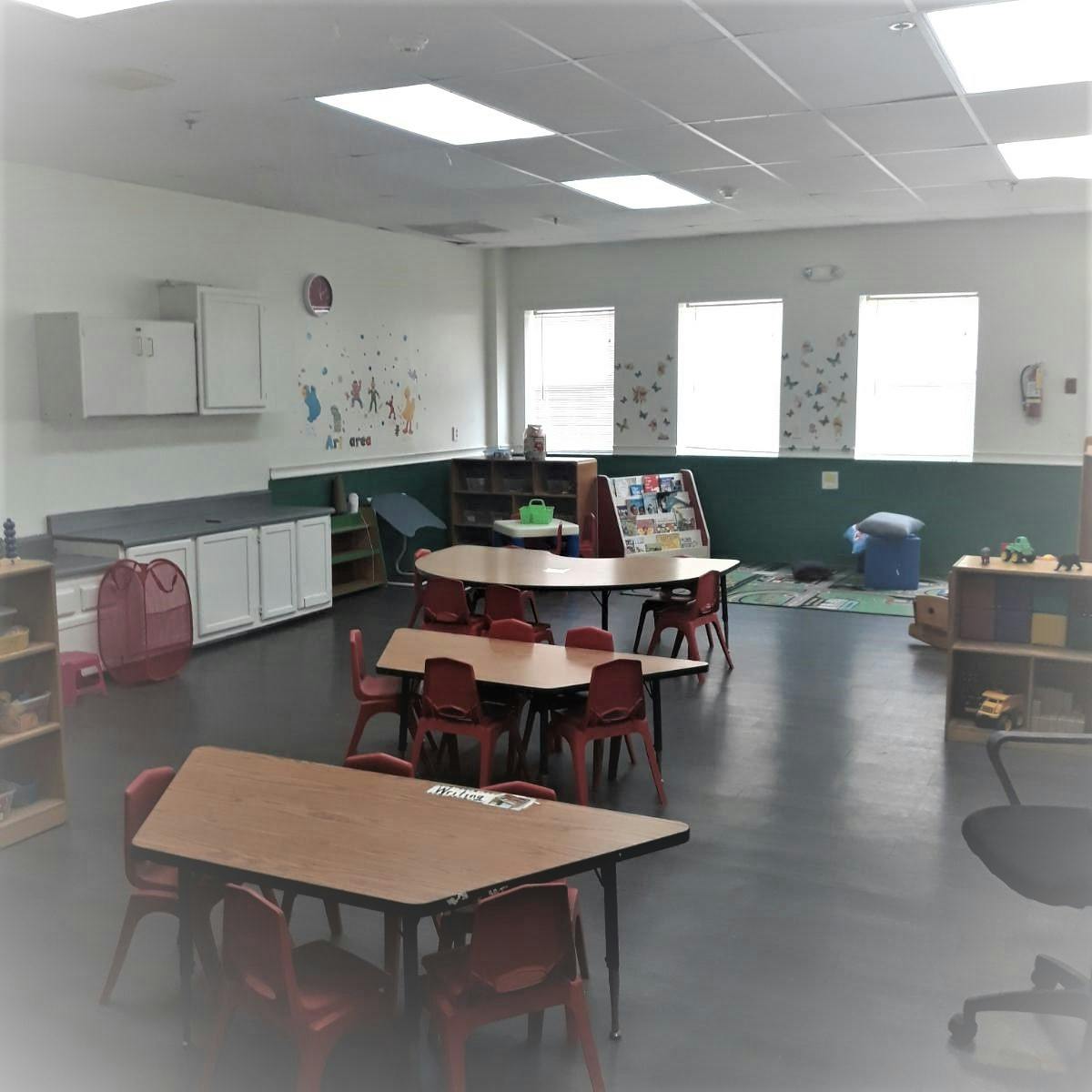 Empty classroom with small tables and chairs