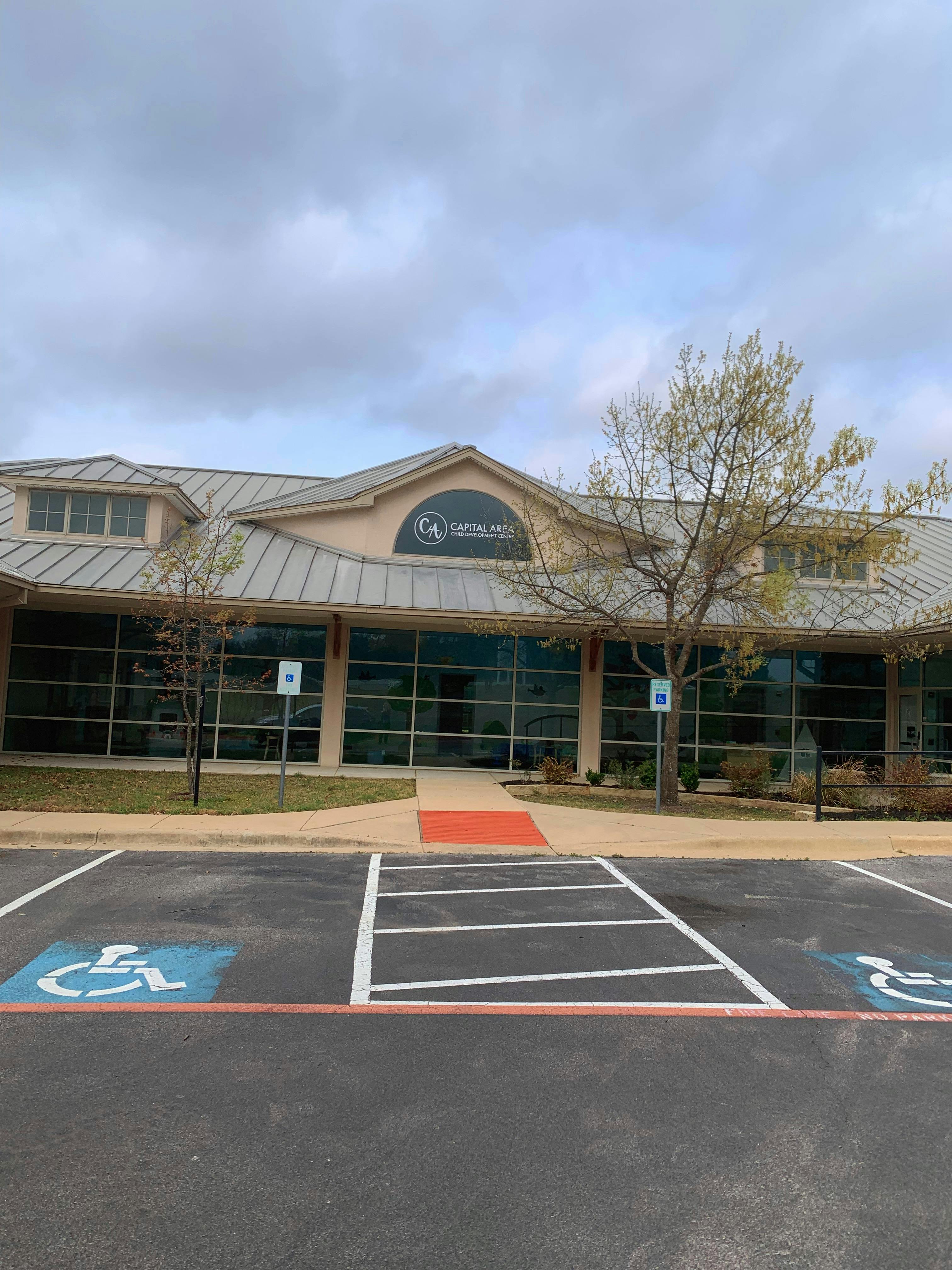 Building exterior with a parking lot in the foreground