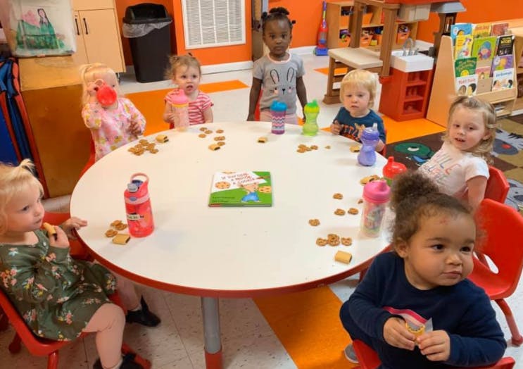 Children sitting around a table with snacks