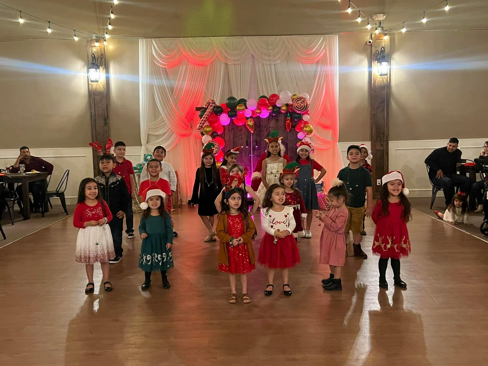 Children in festive attire standing in a room