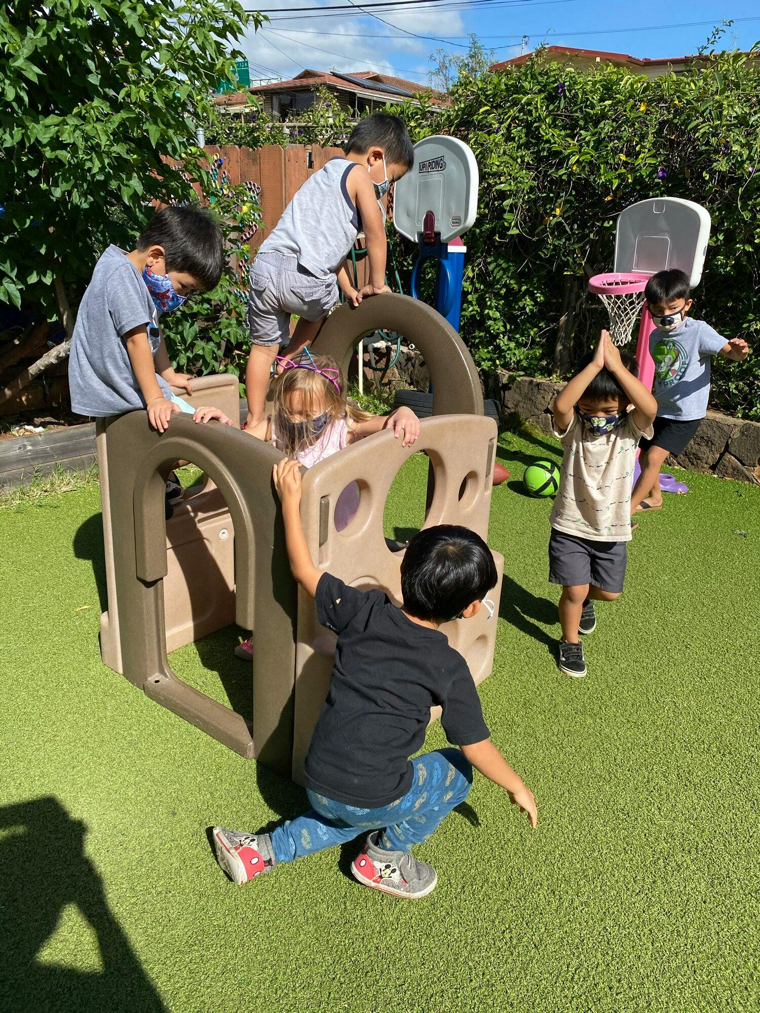 Children playing on a playground structure outdoors