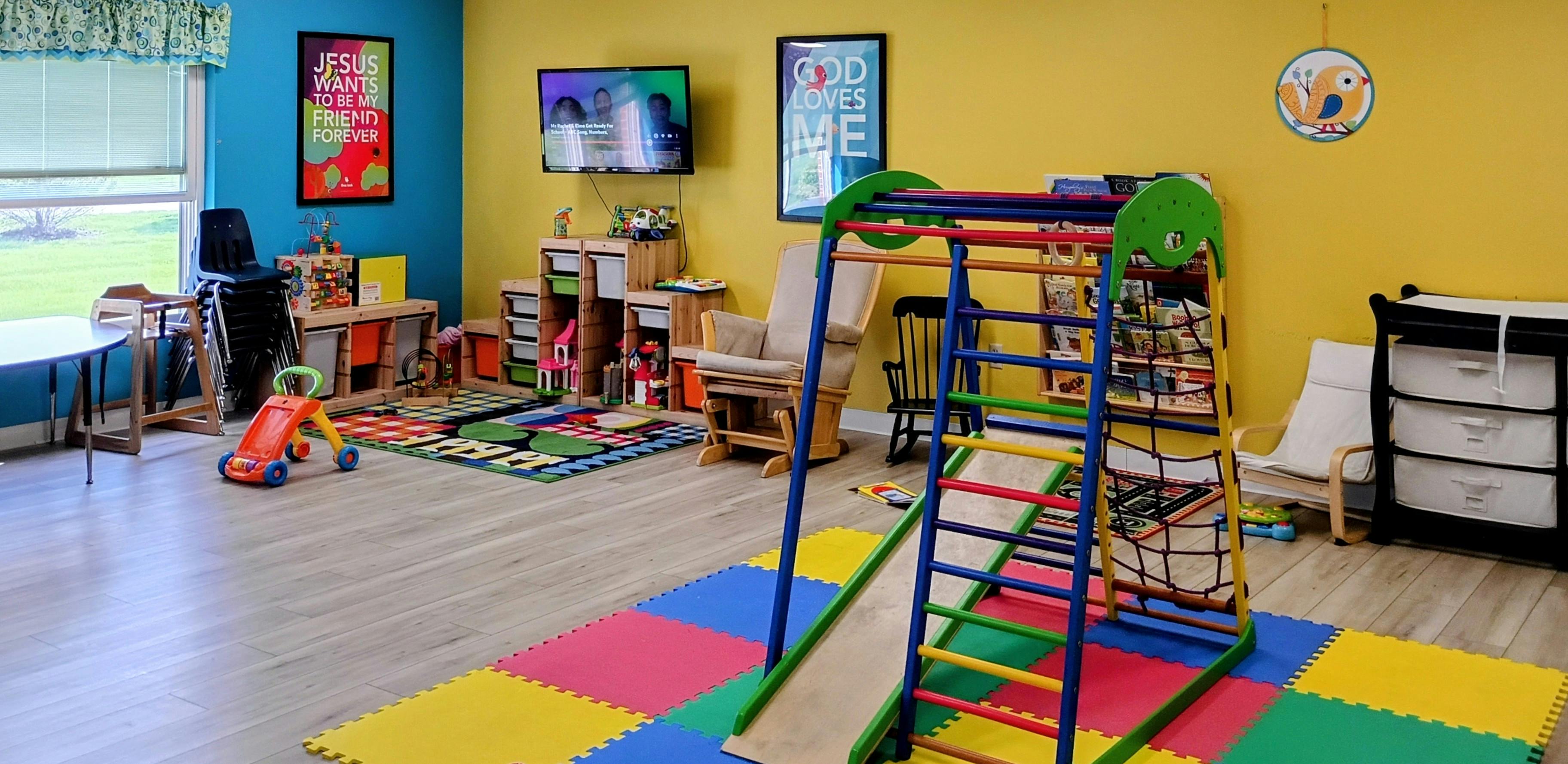 Colorful playroom for children featuring a small climbing structure and toys
