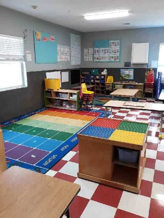 Classroom with a rainbow rug and red and white checkered floor