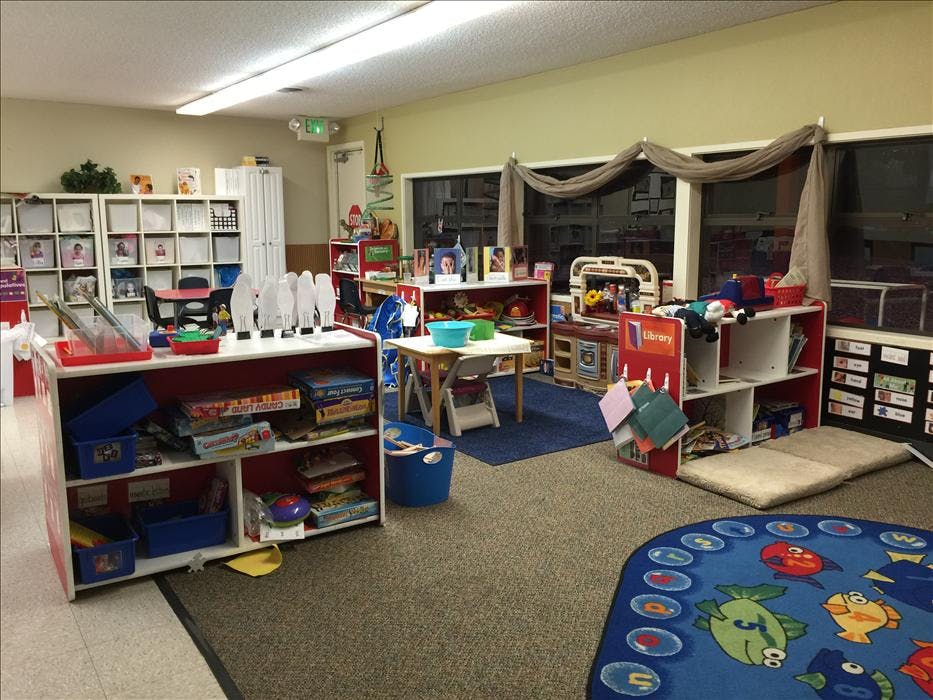 Classroom filled with toys, books, and children's furniture