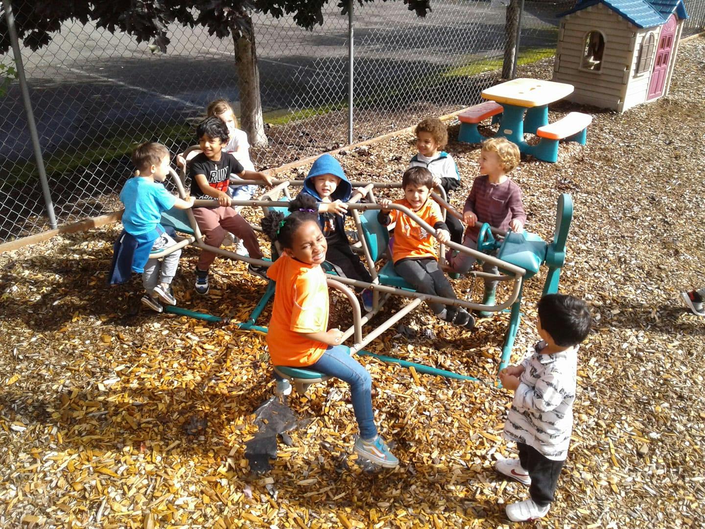 Children playing on a playground seesaw