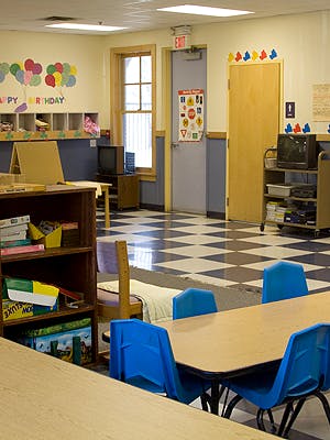Empty classroom with tables, chairs, and checkered floor