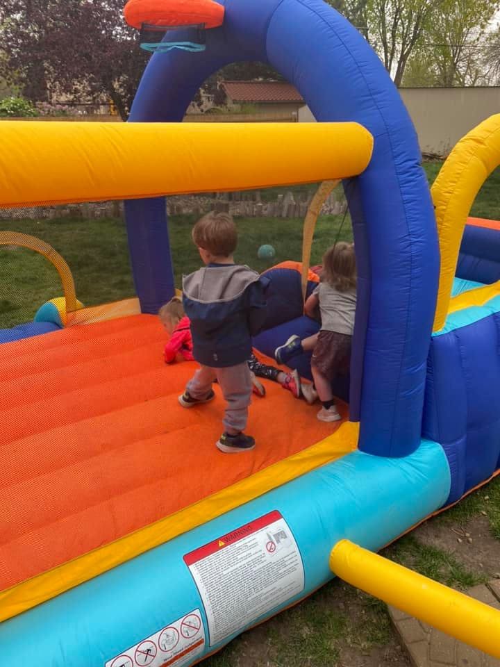 Children playing on an inflatable bounce house