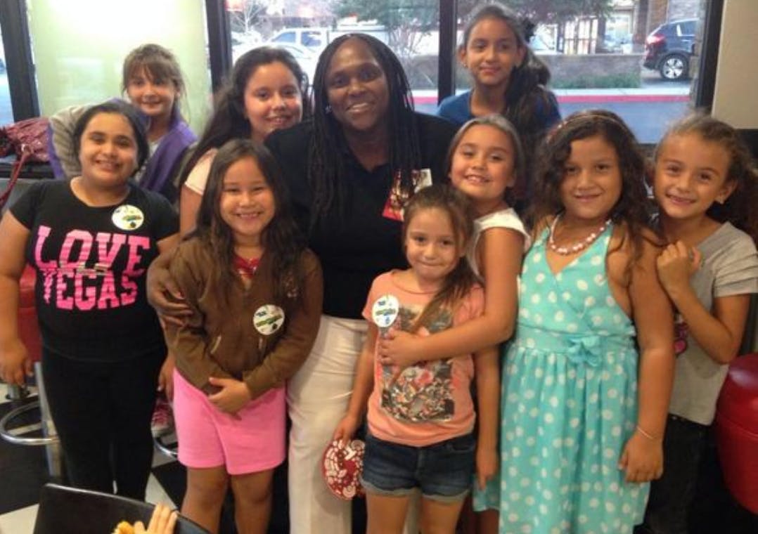 Adult and group of children posing for a photo