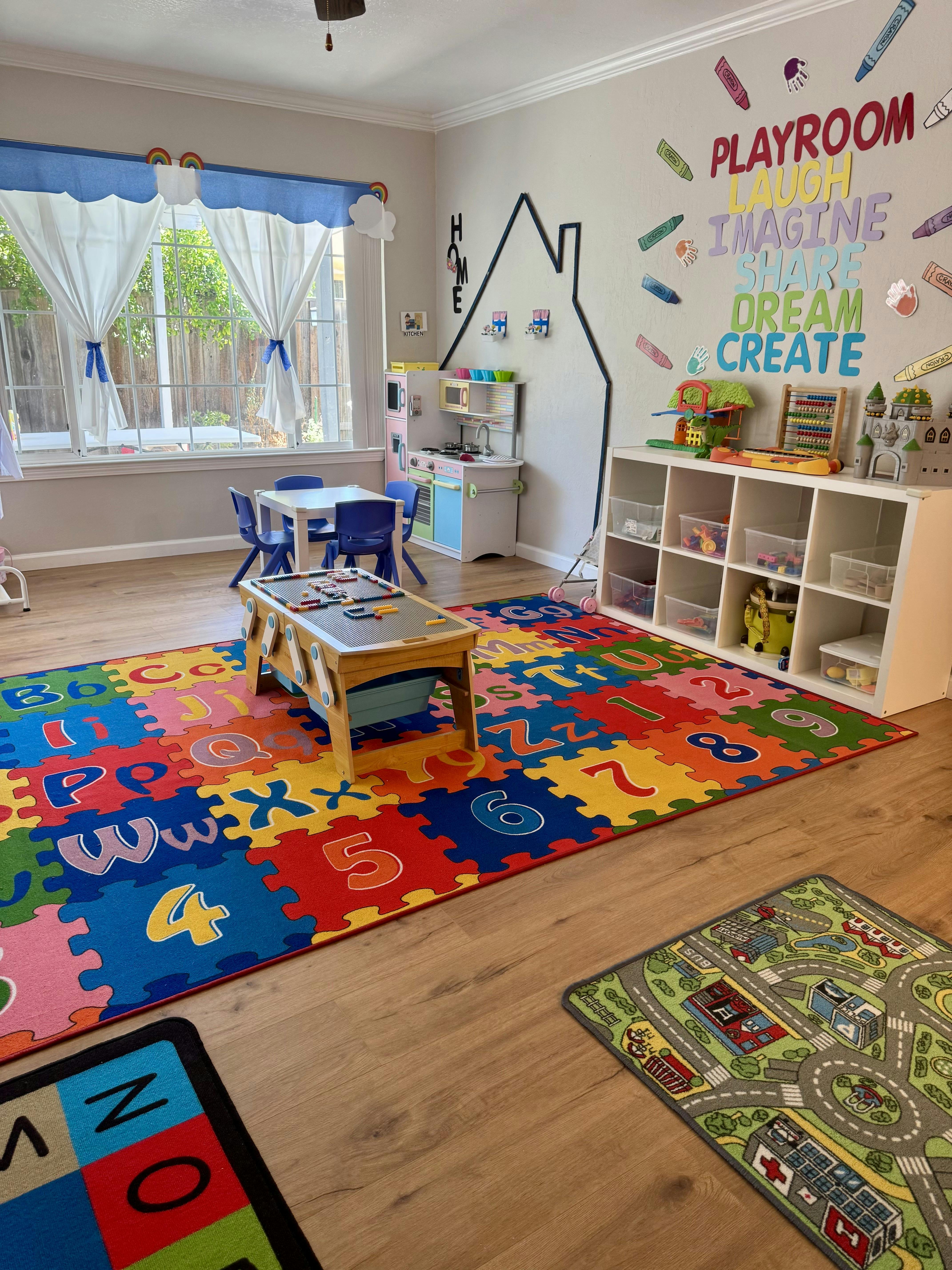 Playroom with colorful alphabet and number floor mats, small table and chairs