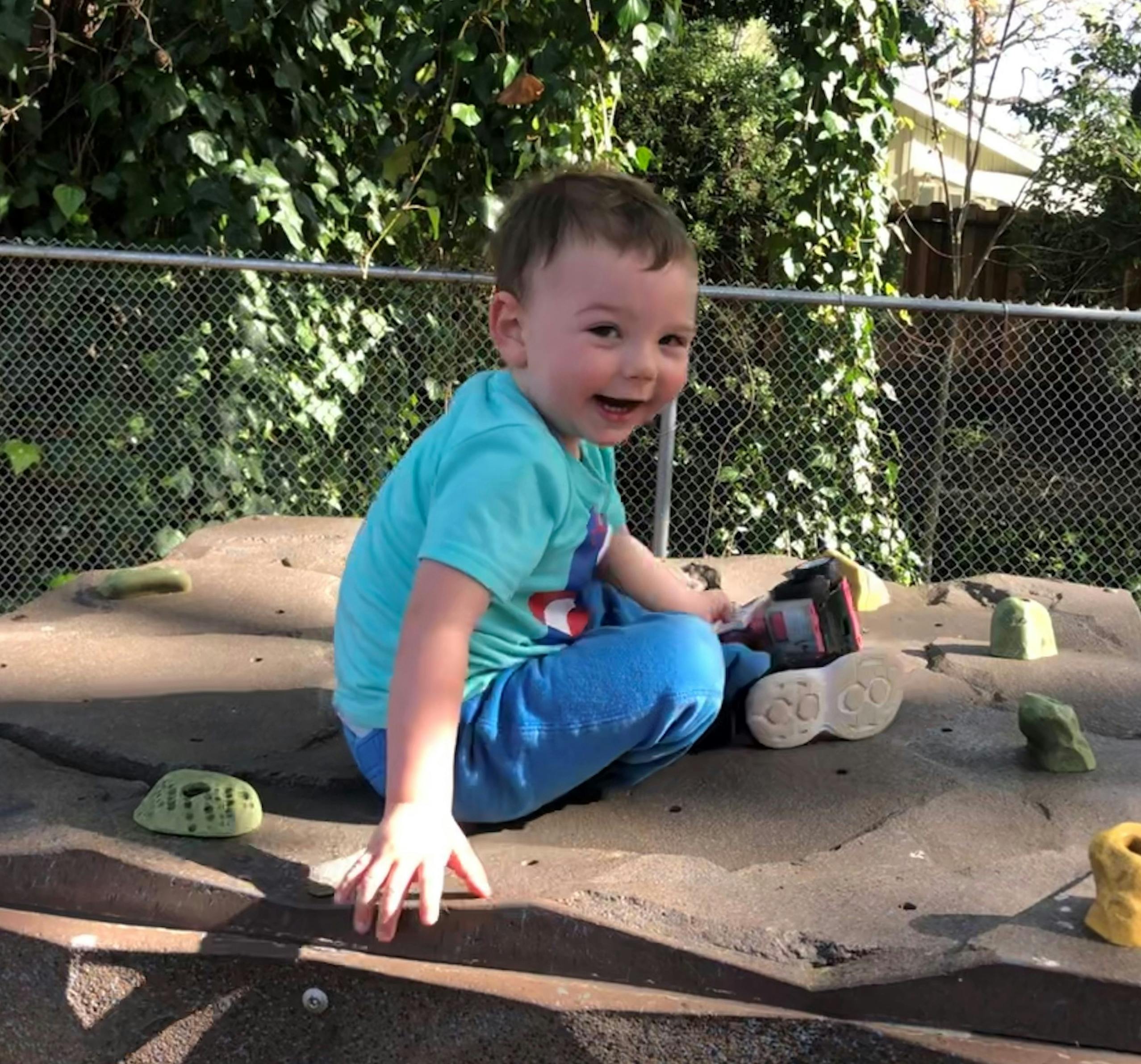 Child sitting on a climbing structure
