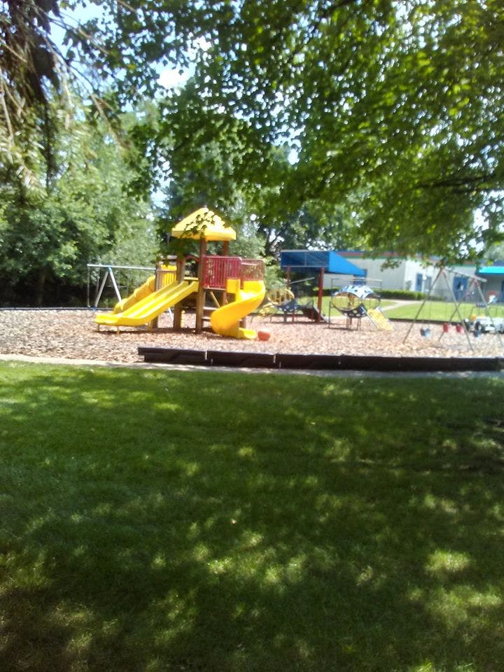 Playground with yellow slides and swings