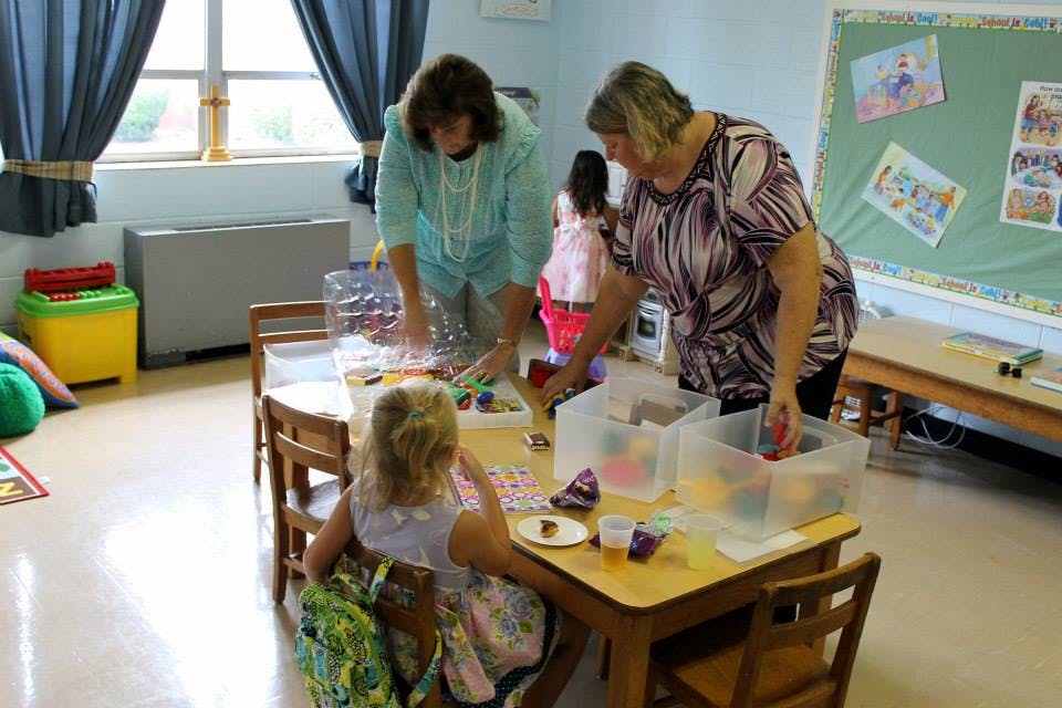 Two people and a child at a table with craft supplies