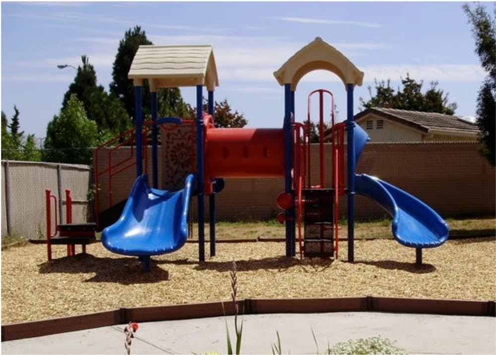 Playground with slides and climbing structures on wood chips