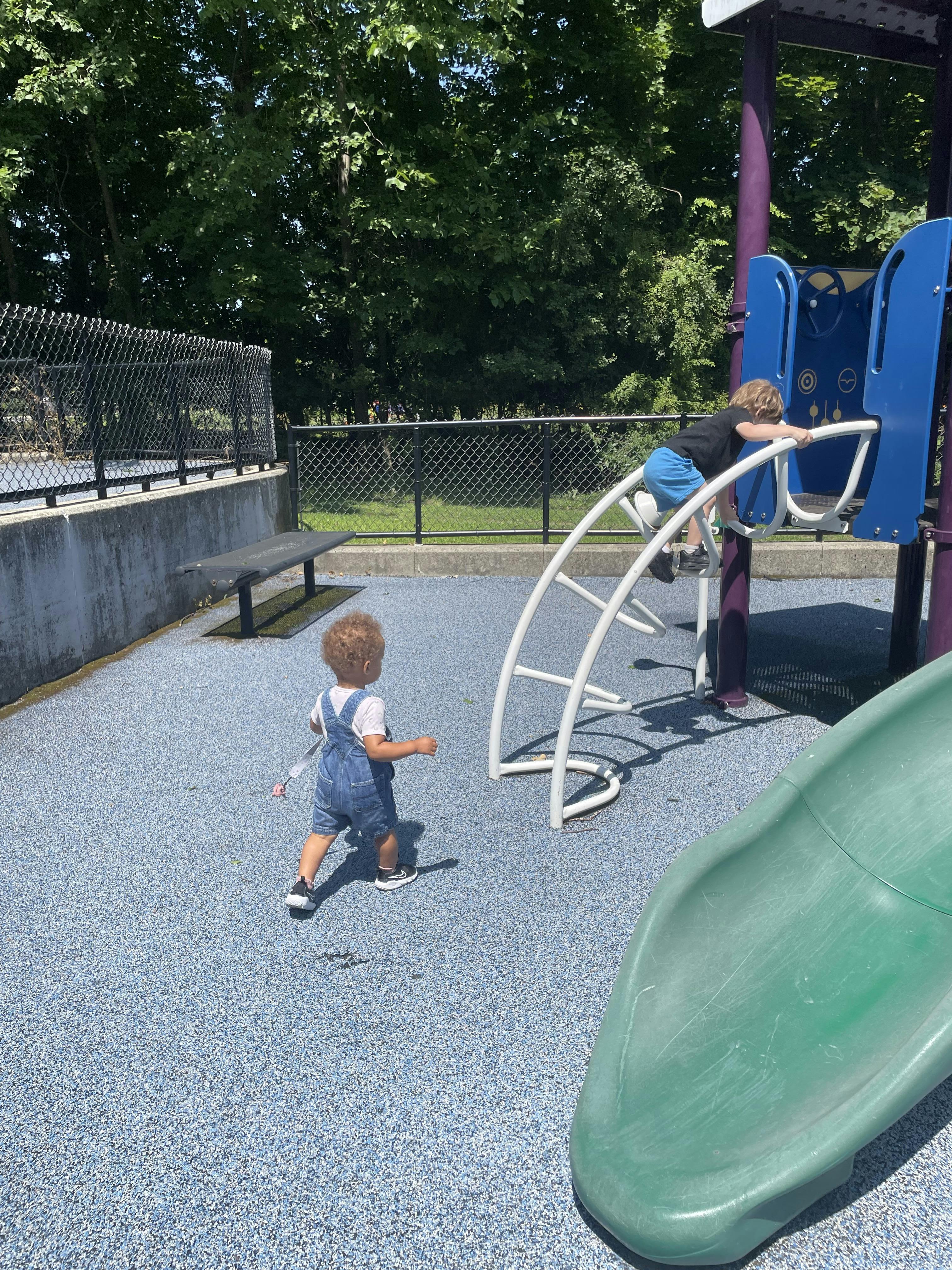 Two children playing on playground equipment