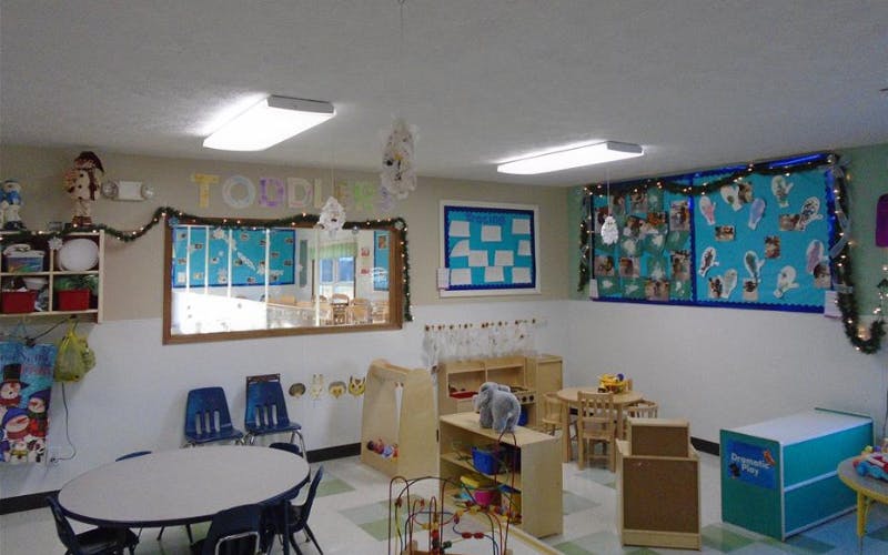 Classroom decorated with seasonal garlands and children's artwork on bulletin boards
