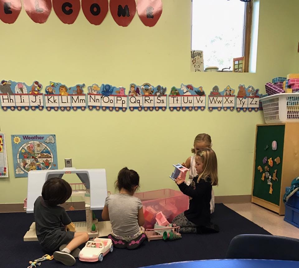 Children playing with toys in a classroom