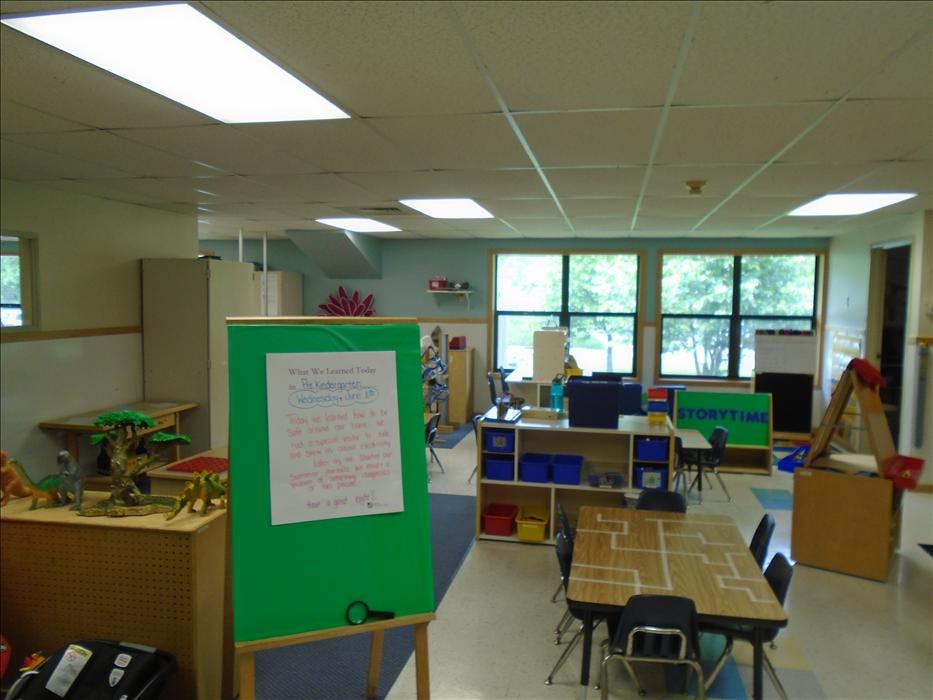 Classroom with tables, chairs, and a whiteboard