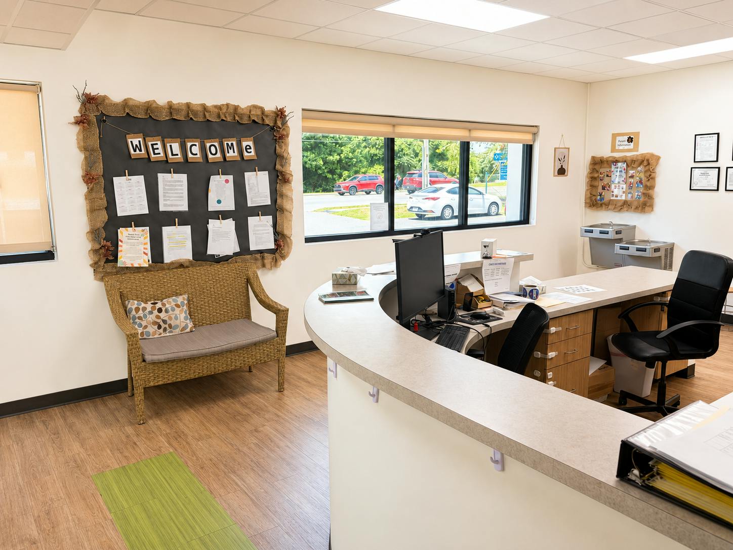 Reception area with a desk, office chair, and a welcome sign on the wall