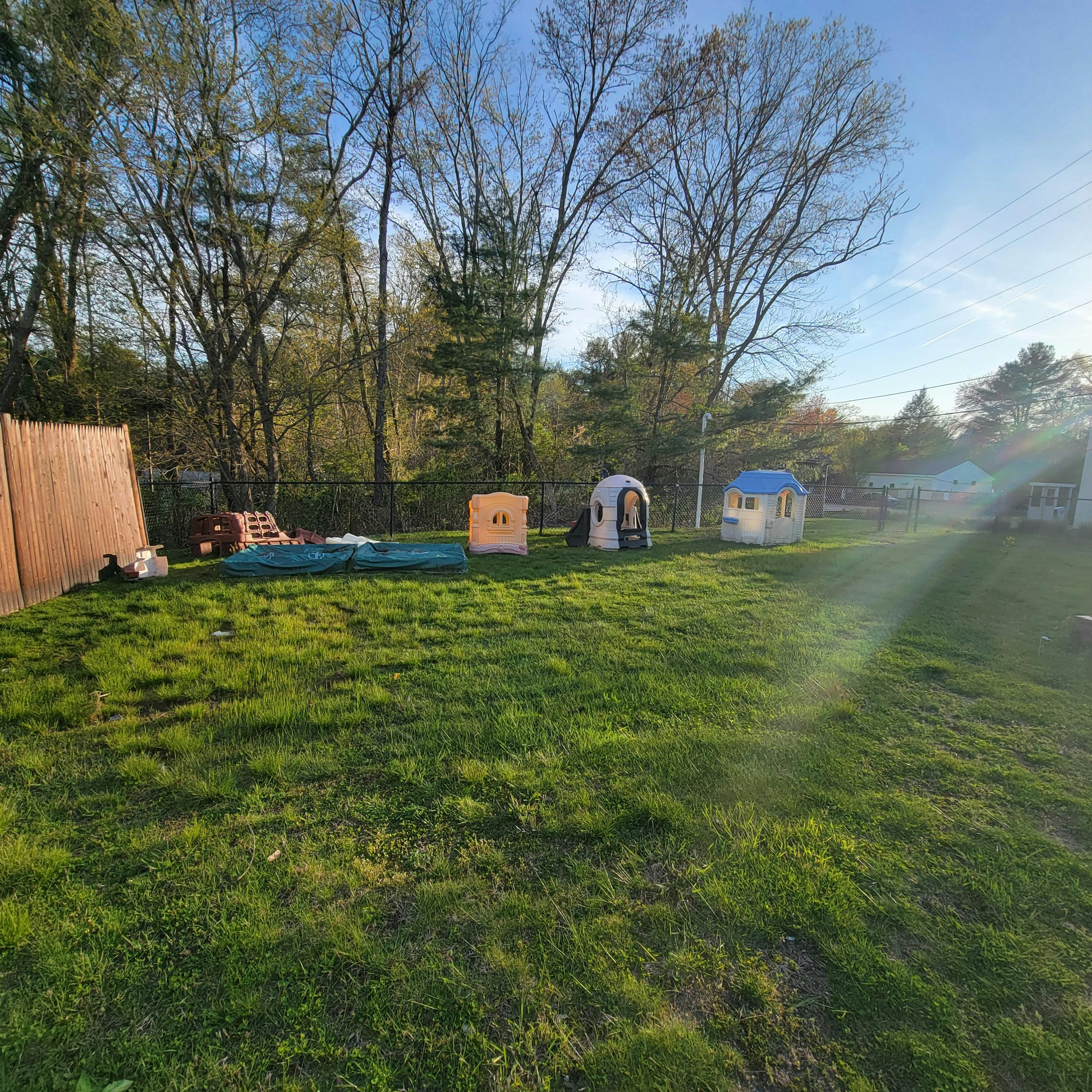 Backyard with playhouses and a fence