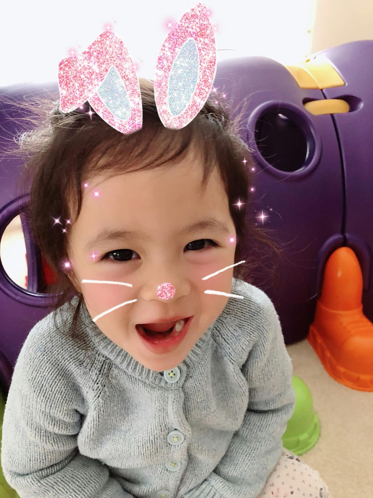 Child with bunny ears and whiskers filter