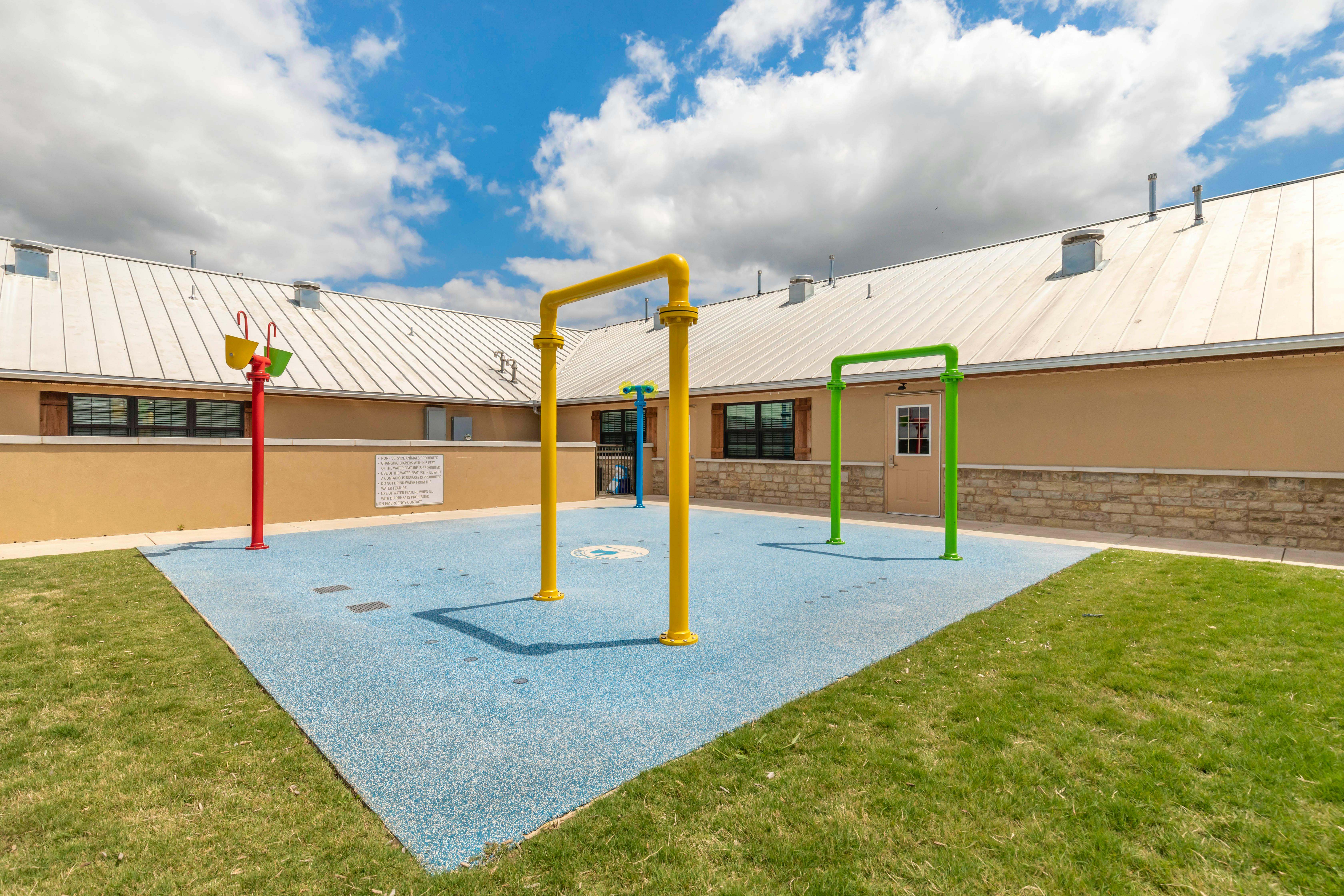 Colorful water playground with a building in the background