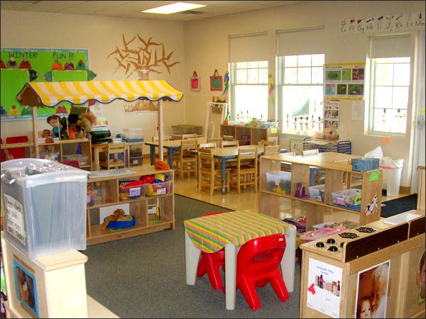 Classroom with play market stall, tables, and chairs