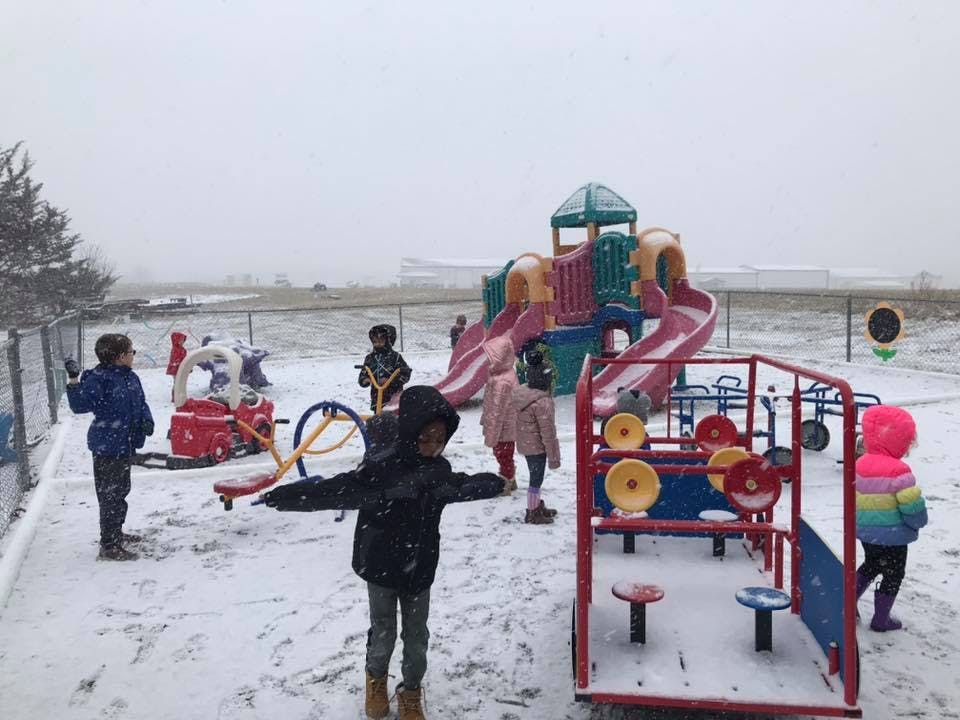 Children playing in a snowy playground