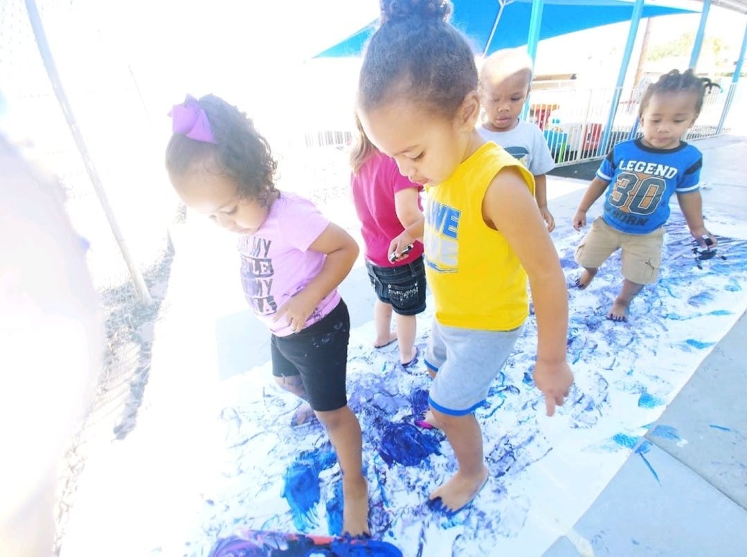 Children playing in blue paint