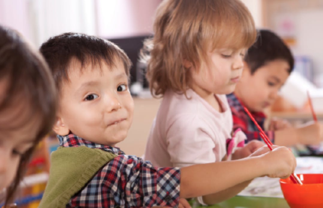 Children painting in a classroom