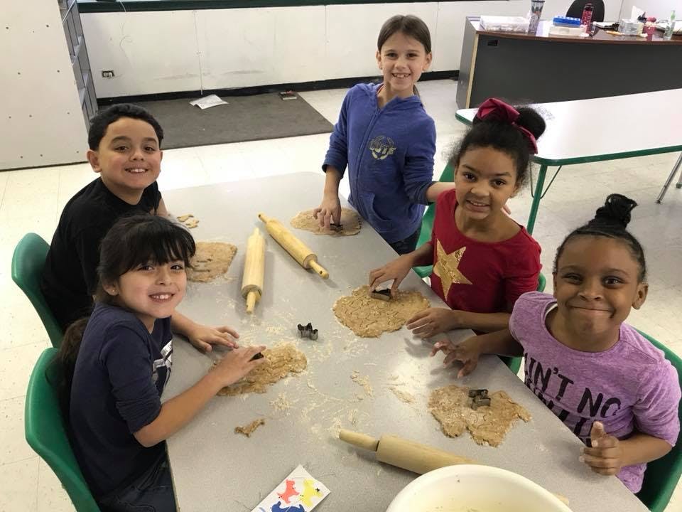 Children making cookies at a table