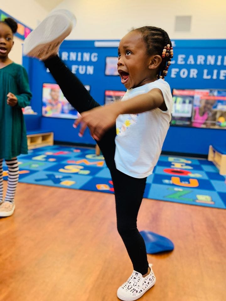 Child kicking leg high in the air