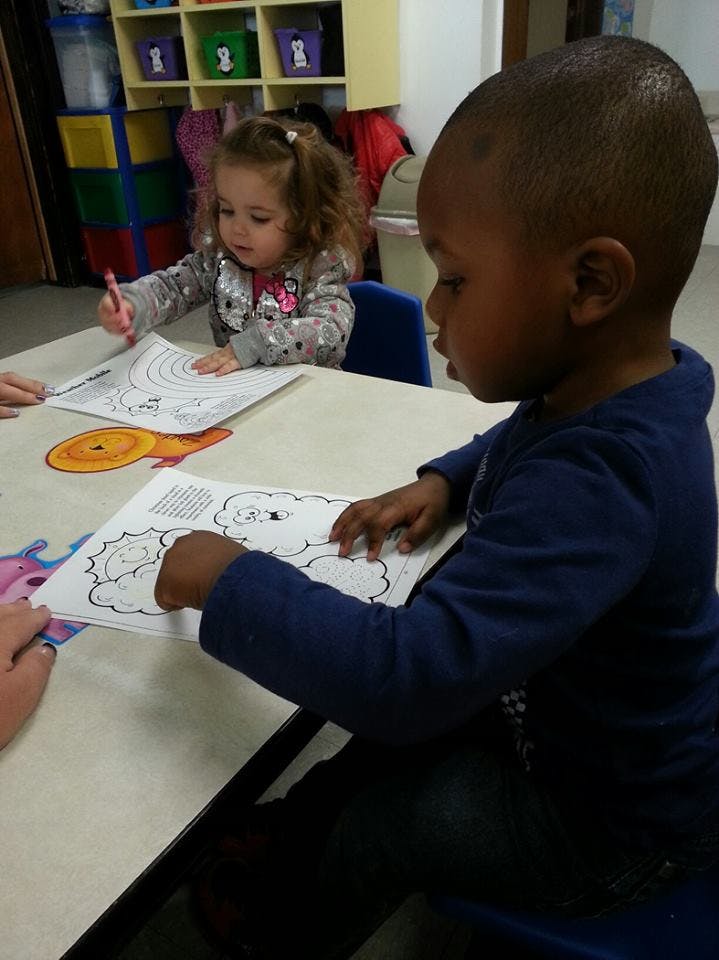 Two children coloring at a table
