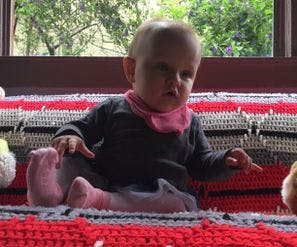 Child sitting on a blanket