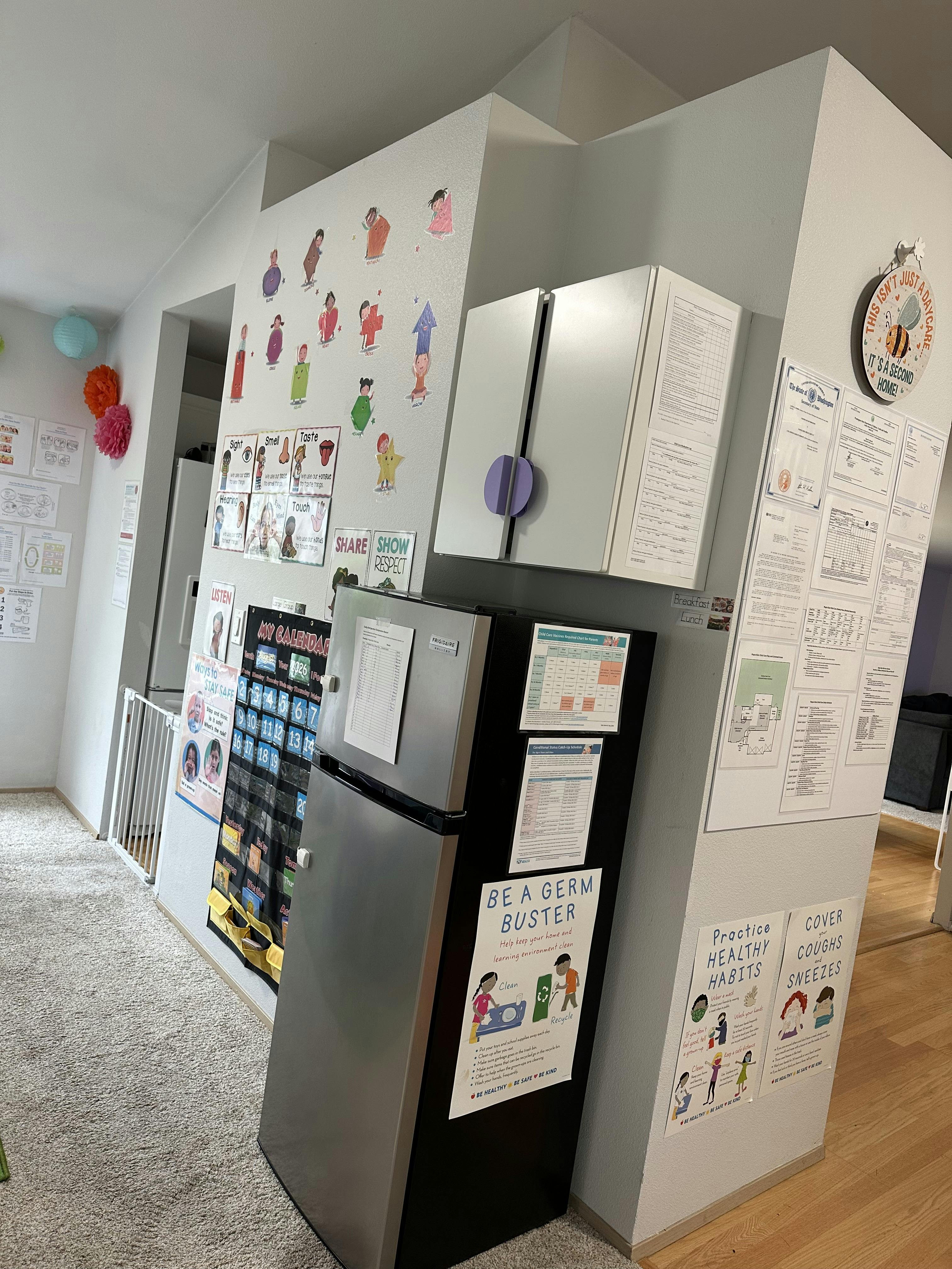 Childcare environment with information posters and a refrigerator