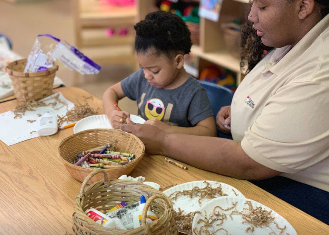 Adult and child at a table with art supplies