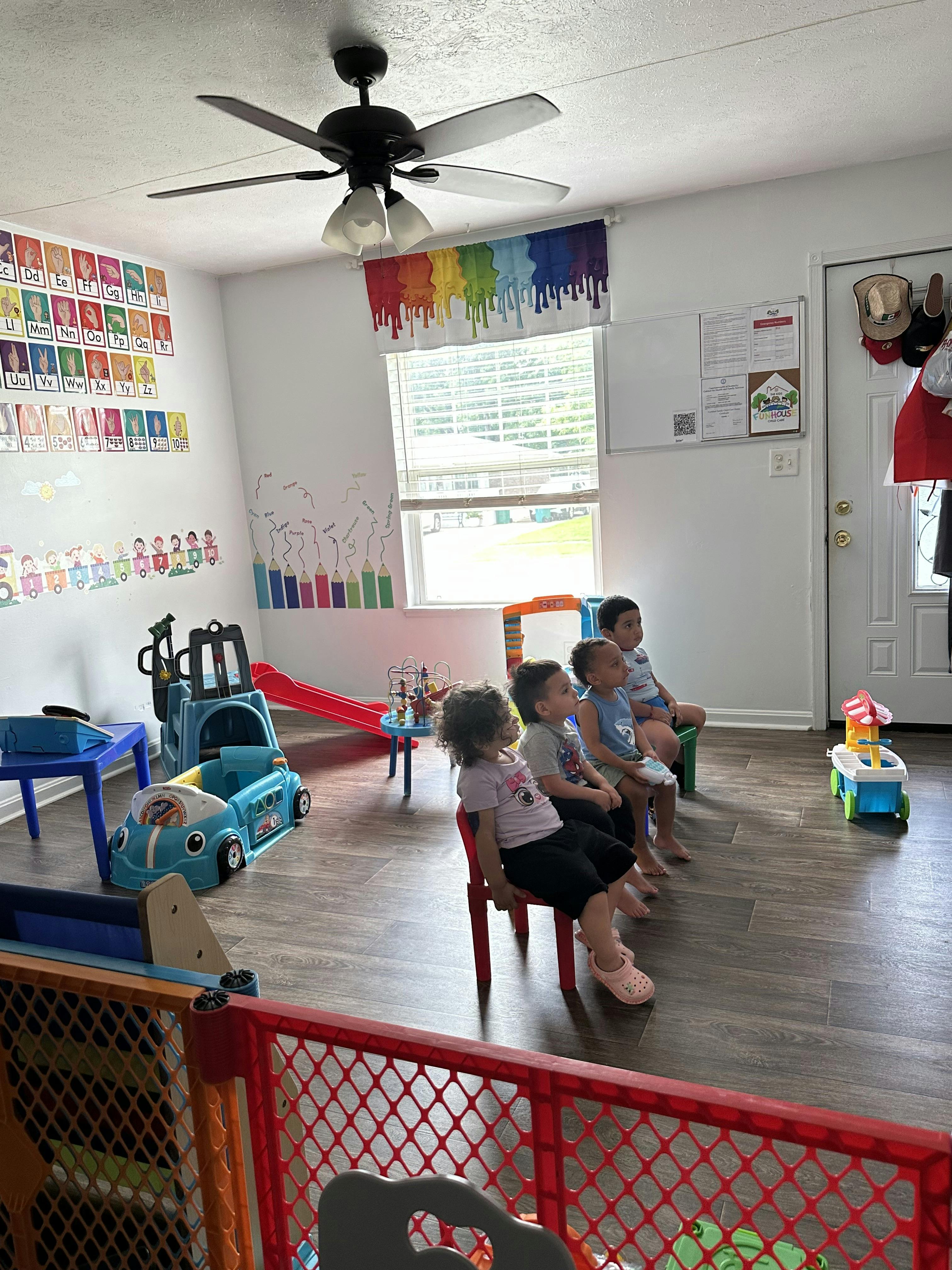 Group of children sitting in chairs in a playroom