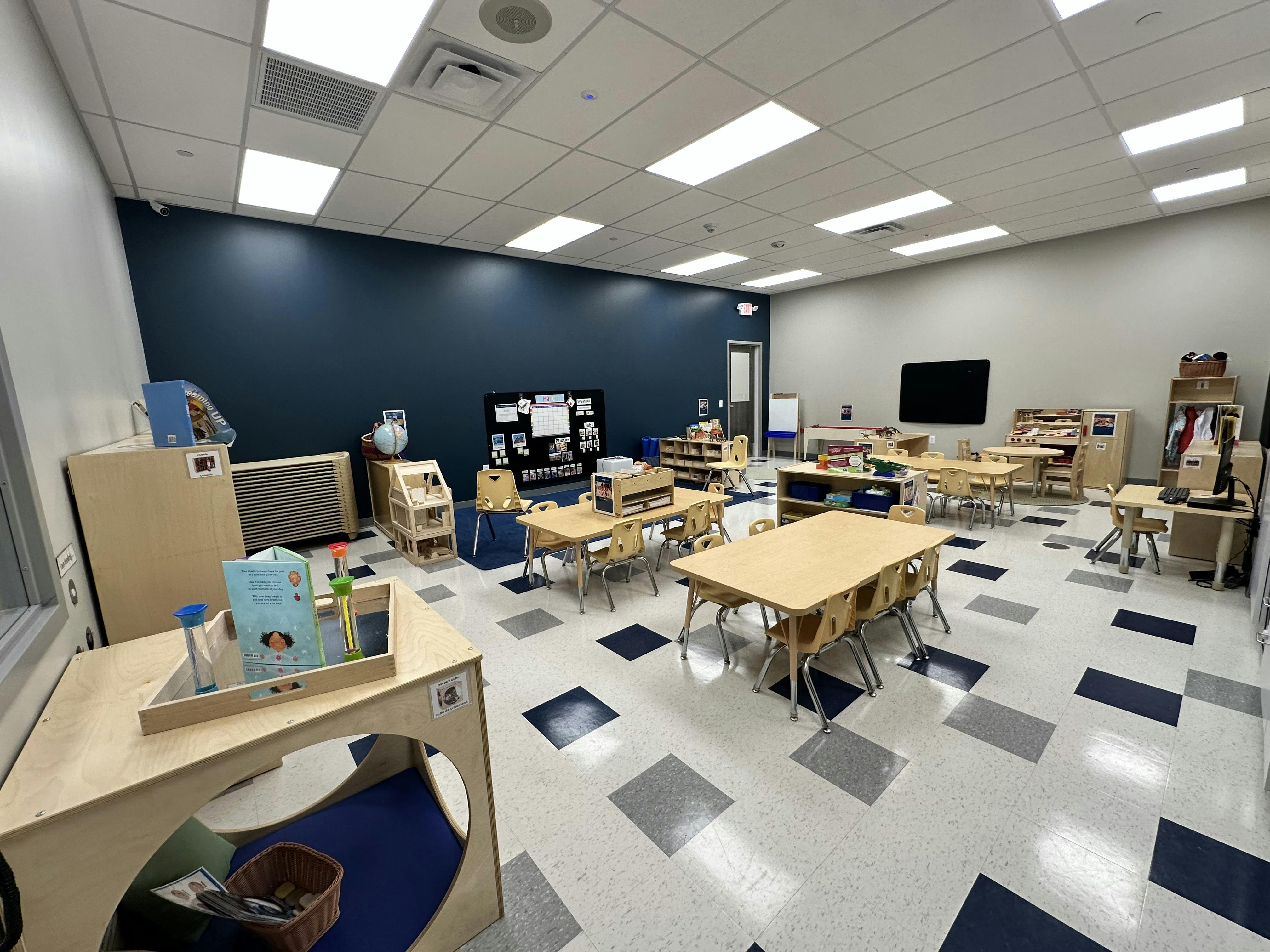 Empty classroom with small tables and chairs
