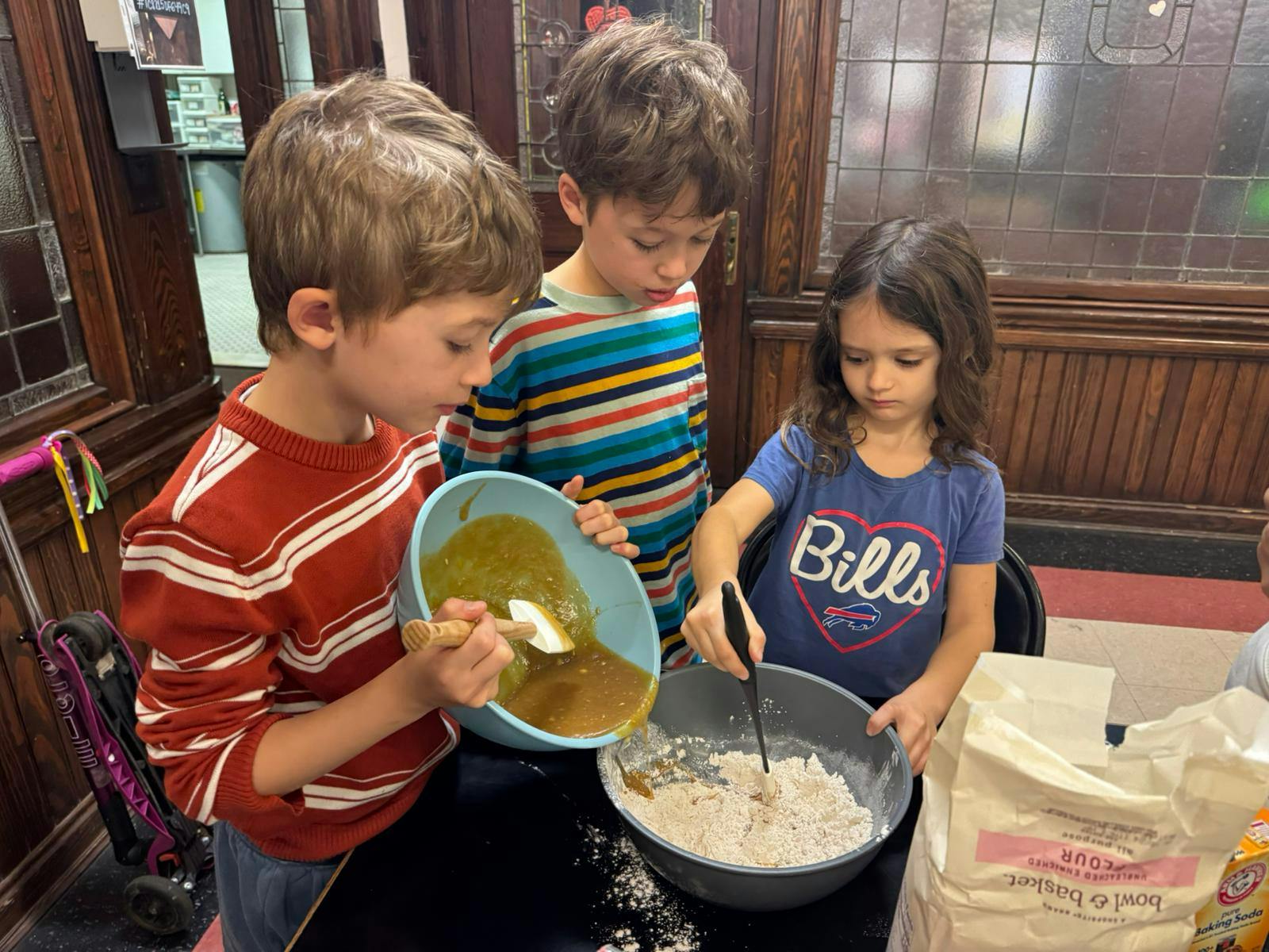 Three children mixing ingredients in bowls