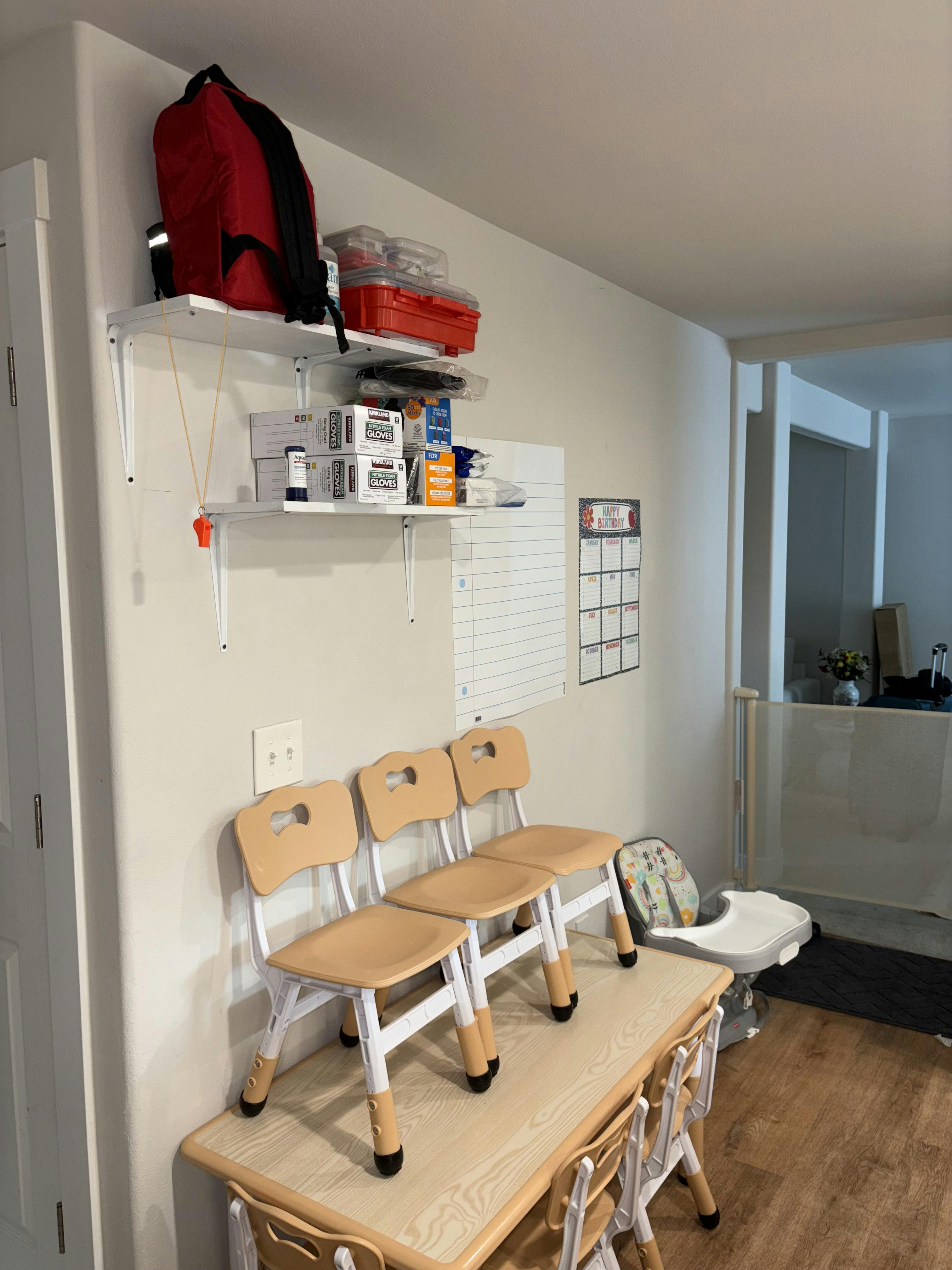 Shelves with items above a table with small chairs