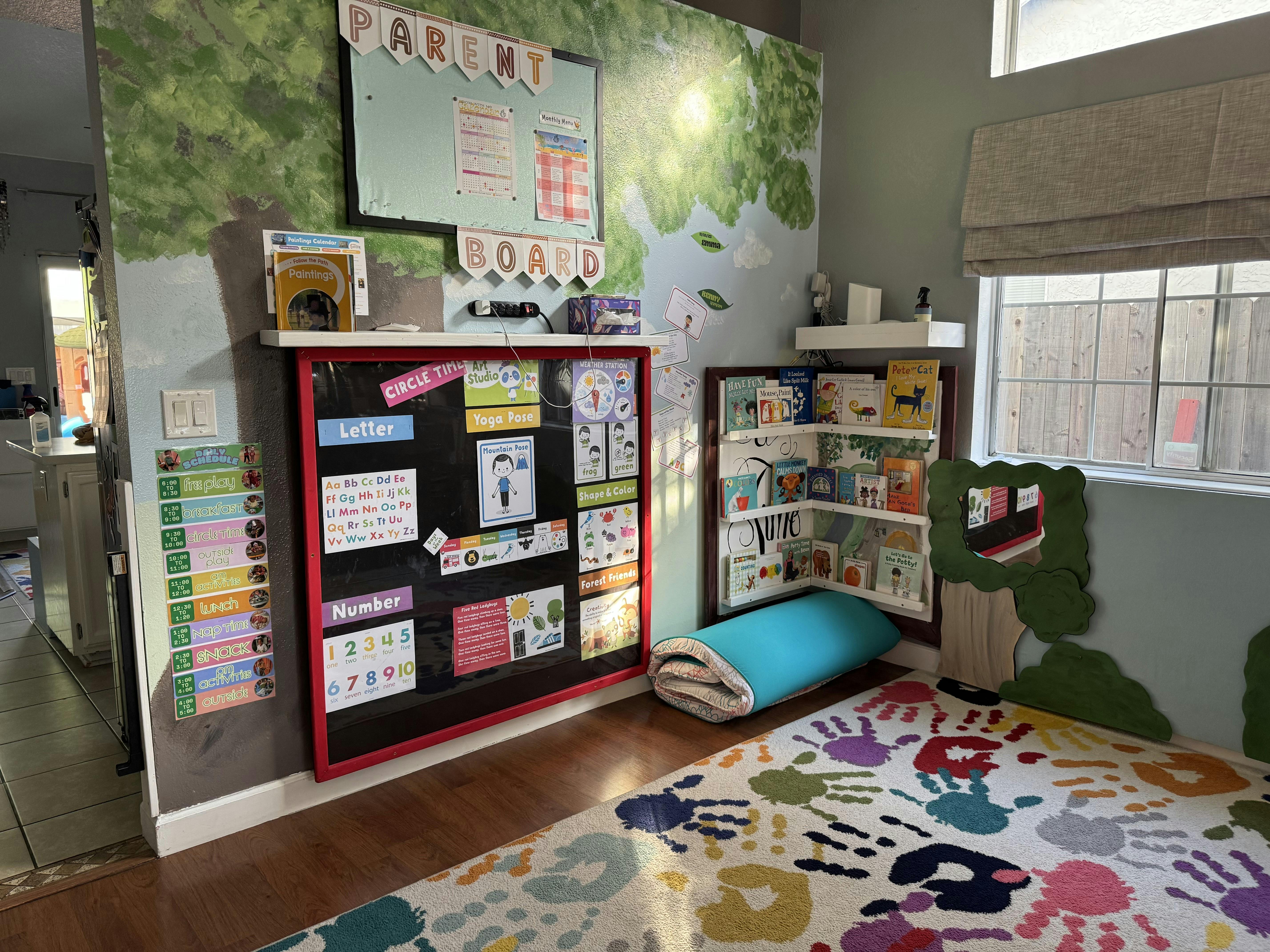 Child's play area with a colorful rug, bookshelf, and activity board