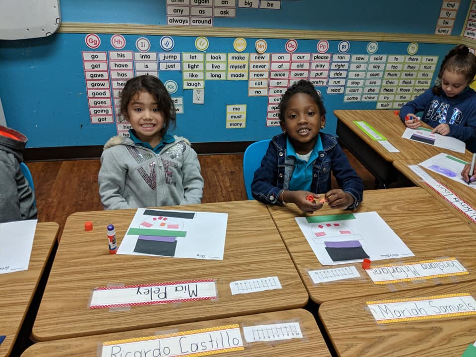 Children sitting at desks in a classroom