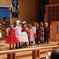 Children in costumes standing on a stage