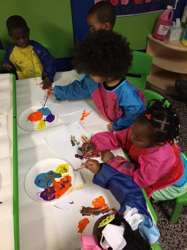 Children painting at a table