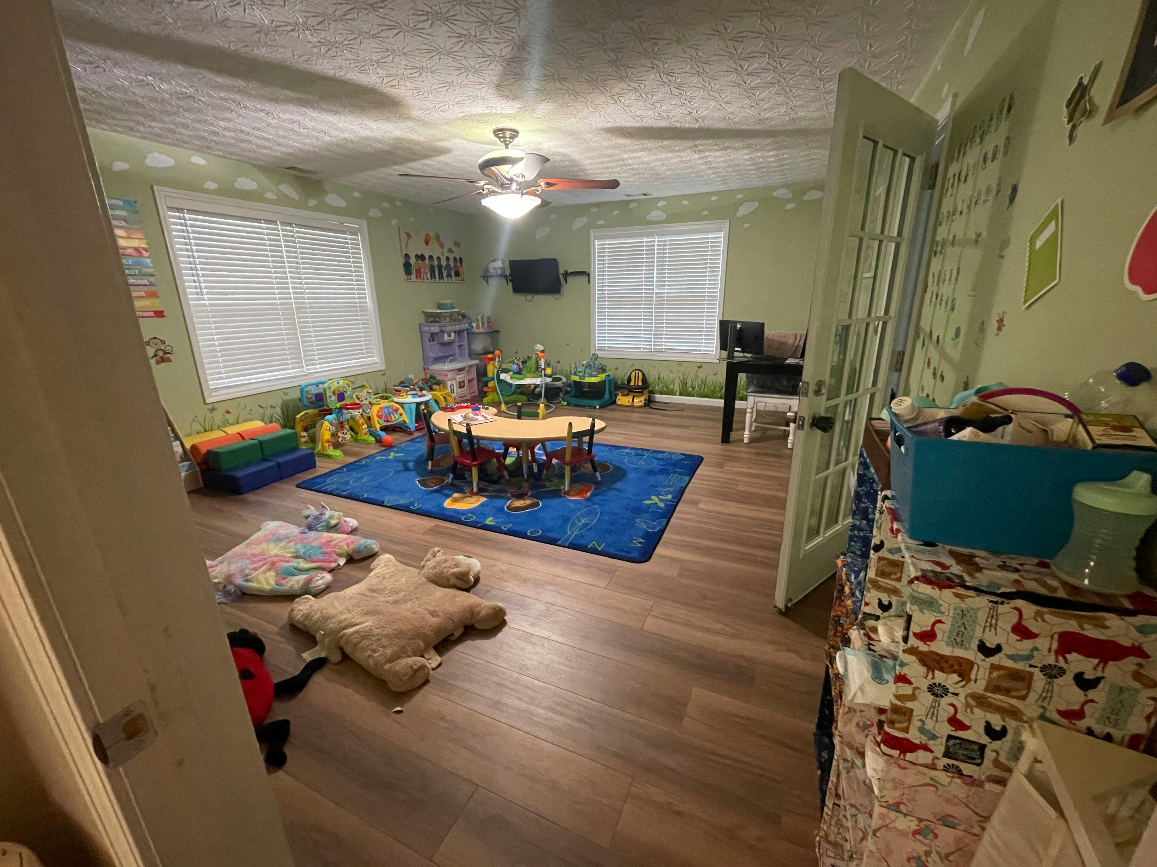 Playroom with a small round table and chairs on a blue rug