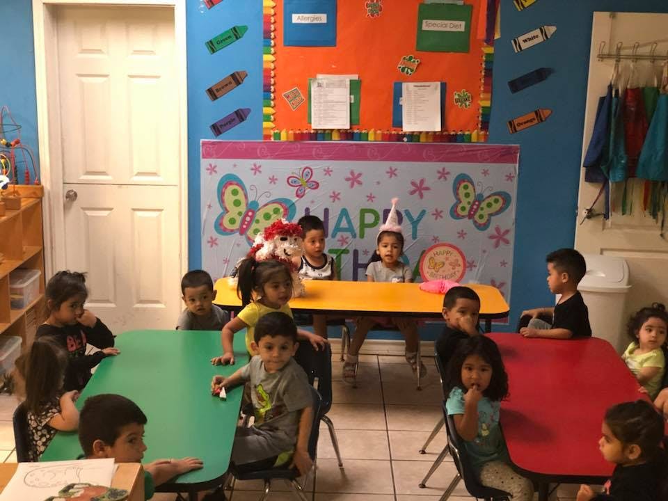 Children sitting at tables in a classroom