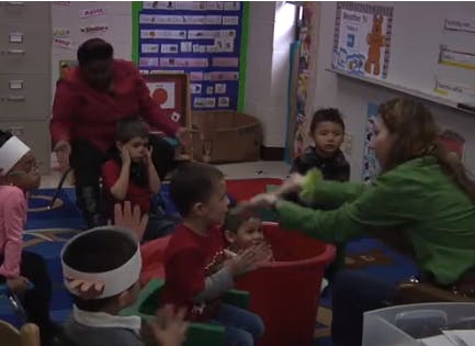 Adults and children in a classroom